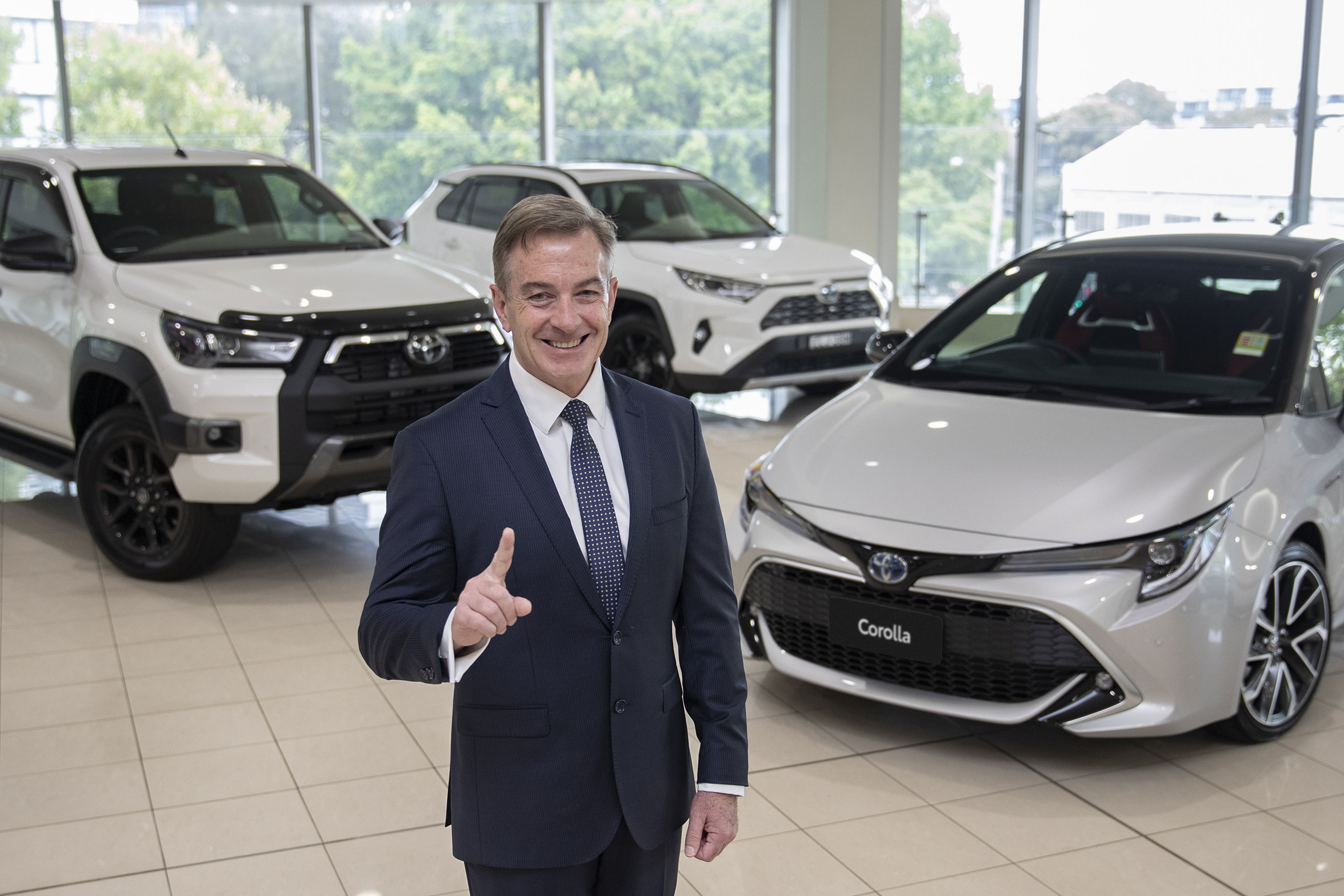 Toyota Australia President & CEO Matthew Callachor with Australia’s top selling vehicle for 2020 Toyota HiLux, top selling passenger vehicle Toyota Corolla and top selling SUV Toyota RAV4.