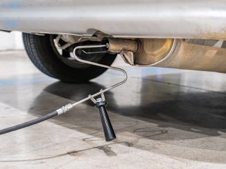 Emission control with a gas sensor in the exhaust of an old car at a vehicle inspection station